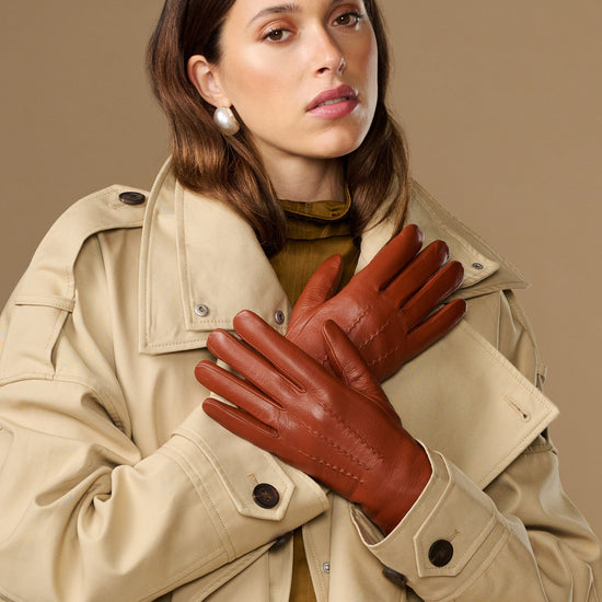 Cognac brown goatskin leather gloves with stitched details and snug fit