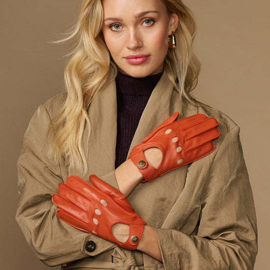 Women's orange lambskin driving gloves with touchscreen fingertips, snap wrist