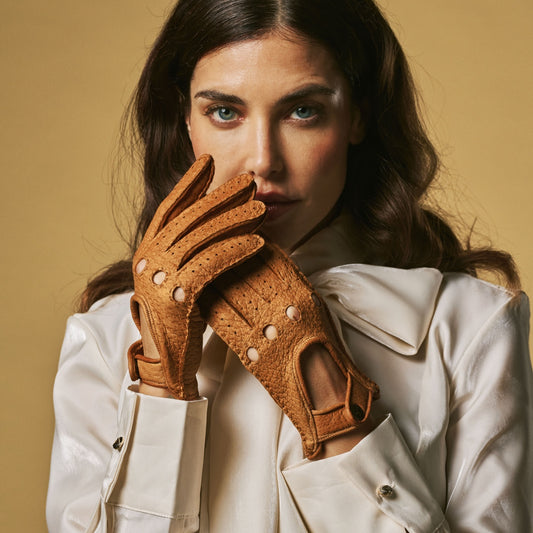Women’s cognac leather driving gloves with perforated cuff and button strap