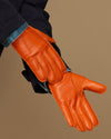 Orange leather gloves with stitched fingers and blue cuff lining detail