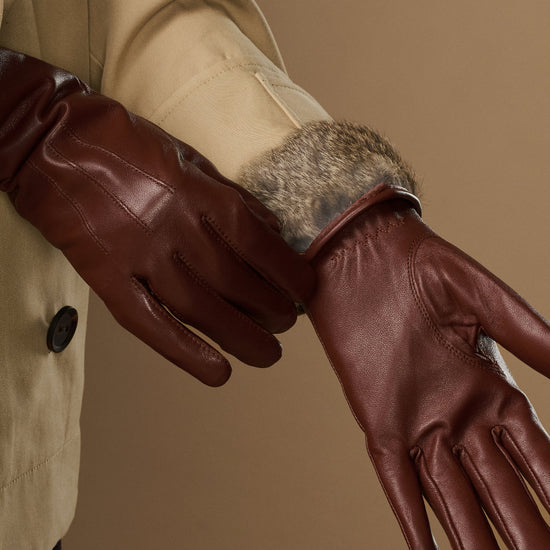 Brown leather glove cuff with visible rabbit-fur lining and seam details