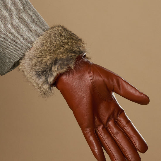 Extra-long cognac leather glove with soft rabbit-fur cuff, close-up