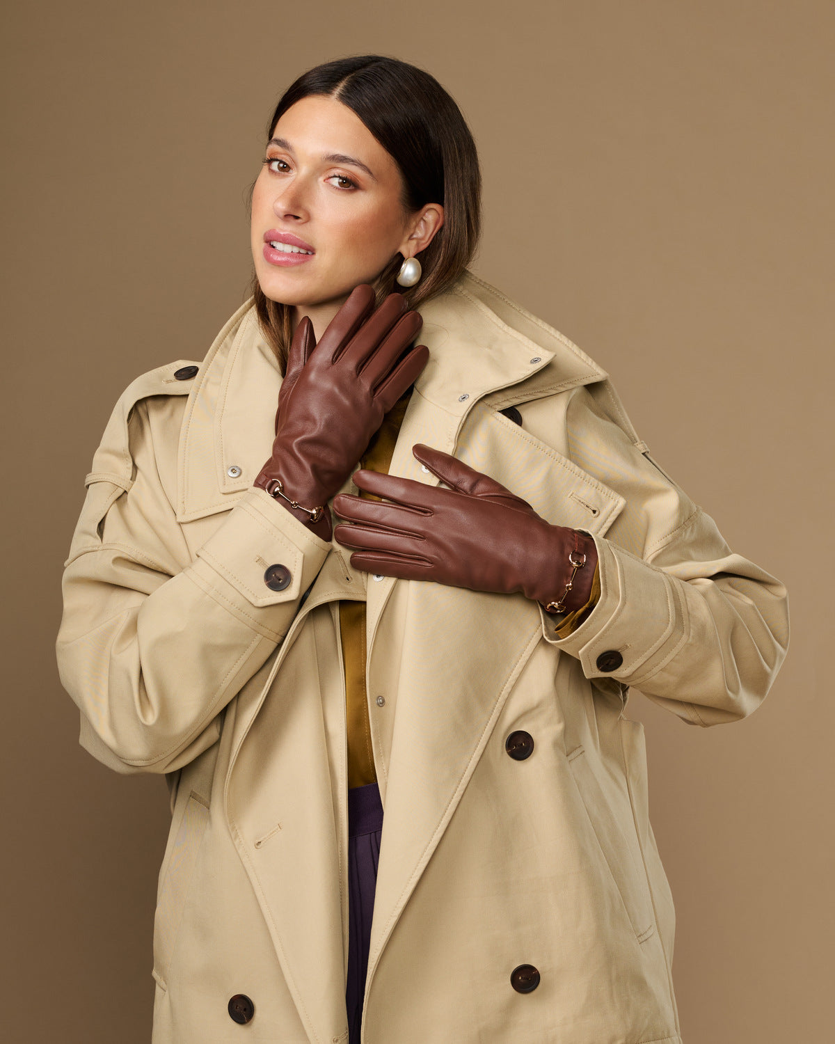 Dark brown lambskin gloves with gold-tone buckle detail and touchscreen fingertips
