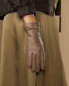 Taupe leather gloves with gold-tone buckle on wrist cuff and five-finger layout