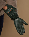 Dark green lambskin driving glove with stitched fingers and curved palm seam