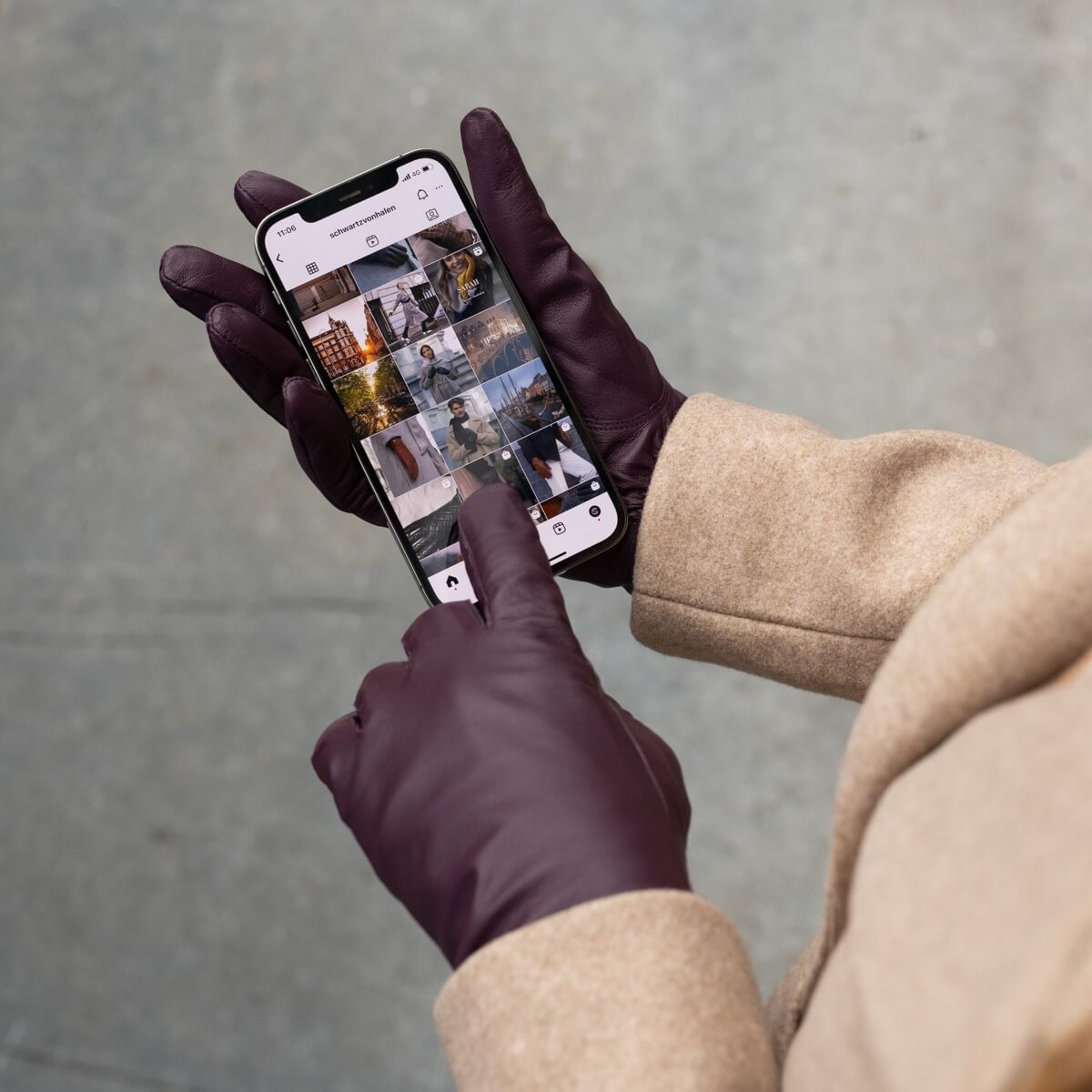 Purple leather touchscreen glove touching a smartphone screen