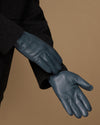 Blue sheepskin gloves with curved finger stitching and soft cuff