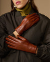 Women’s cognac leather gloves with smooth seams and fur-lined cuff edge