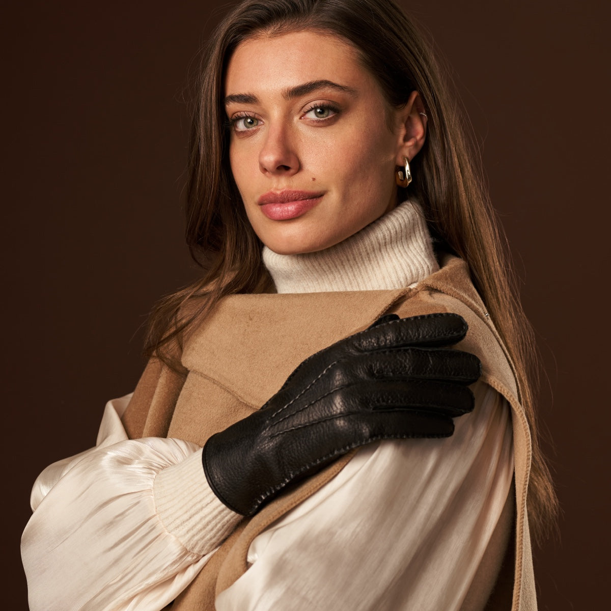 Woman holding her hands together, showing black leather gloves
