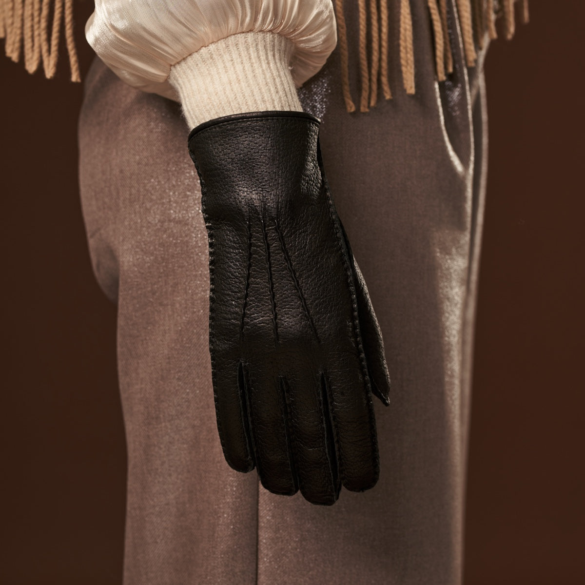 Close-up of woman's black leather glove on her hand