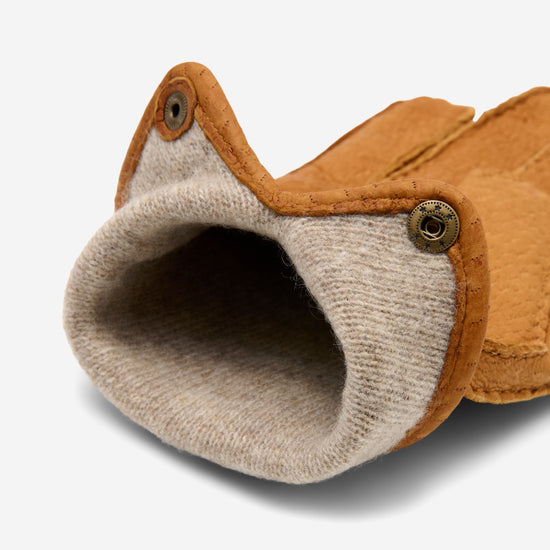 Cognac leather glove cuff with visible cashmere lining and button detail