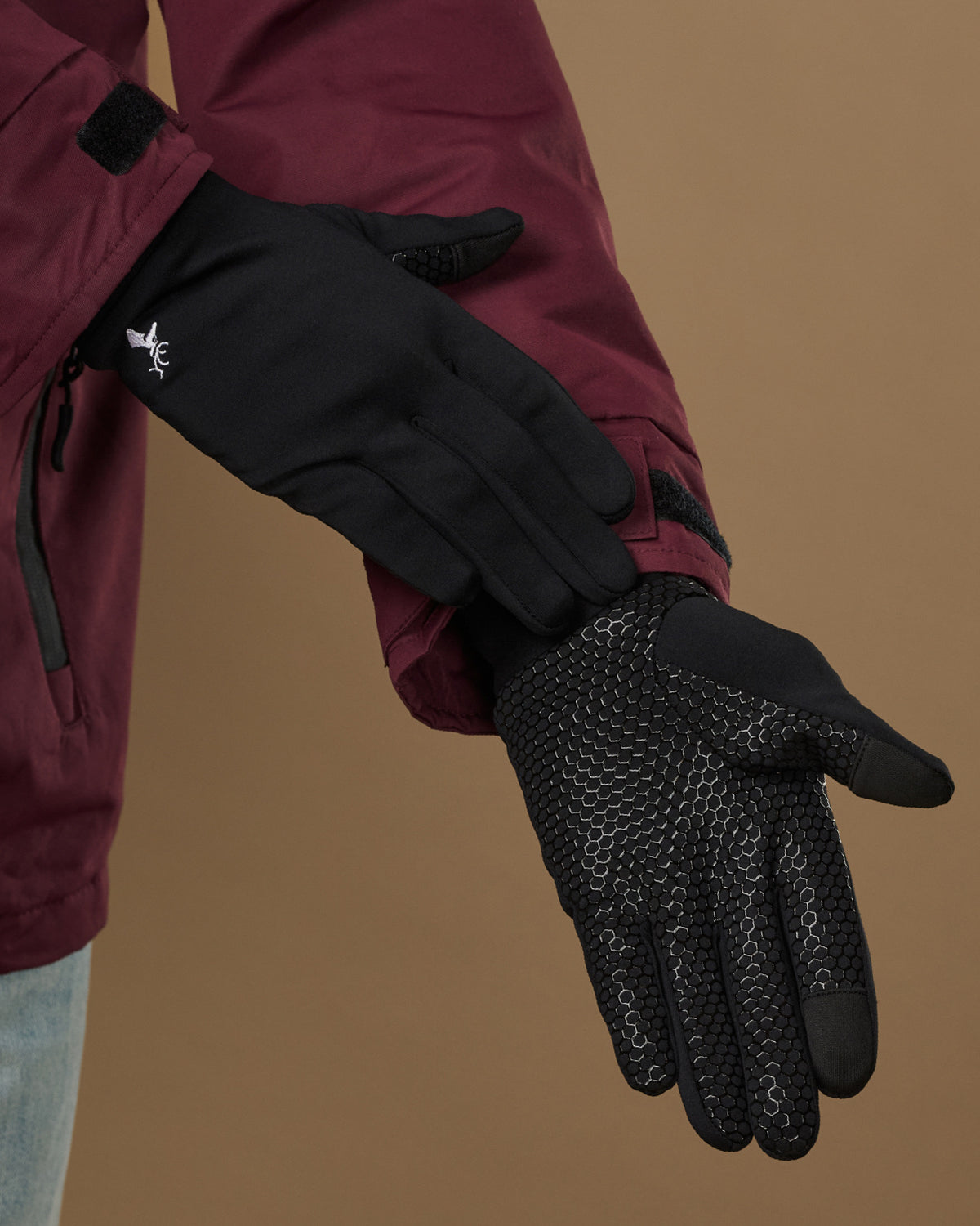 Black activity gloves shown palm-side with textured grip pattern