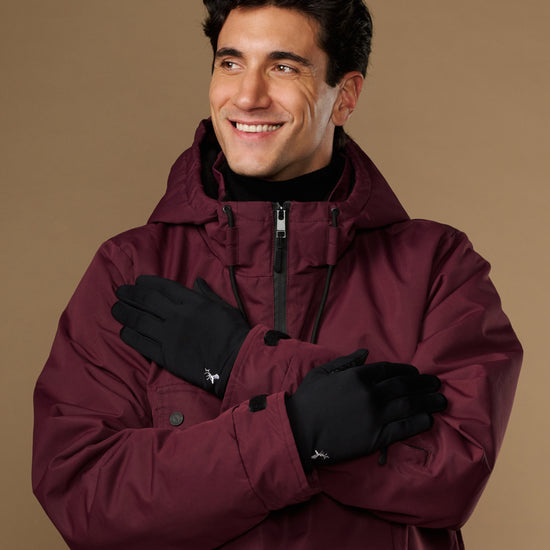 Black activity gloves worn crossed over the chest, showing their smooth backs