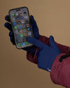 Blue touchscreen activity gloves used to tap a smartphone
