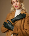 Pair of dark green leather gloves with smooth finish, stitched fingers, and snug cuffs