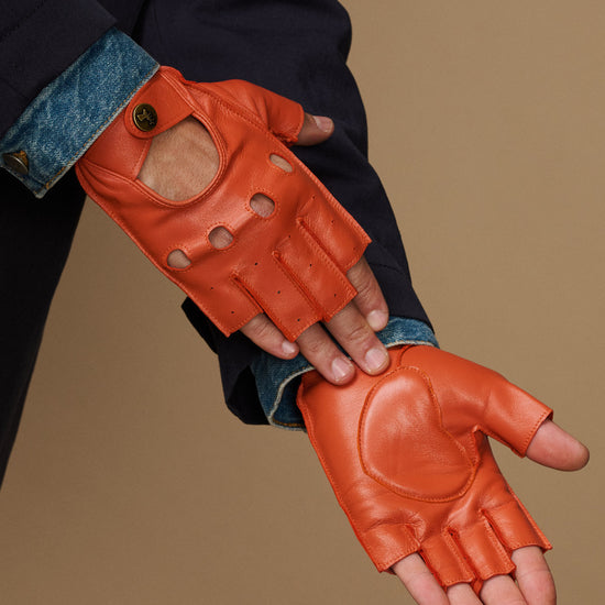 Men's orange fingerless lambskin driving gloves with open finger holes and padded thumb