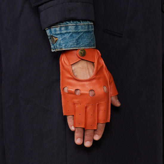 Men's orange fingerless lambskin driving glove with open finger design and logo snap