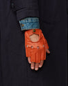 Men's orange fingerless lambskin driving glove with open finger design and logo snap
