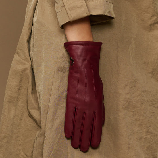 Bordeaux leather gloves with close-up fleece-lined cuff and stitched seams
