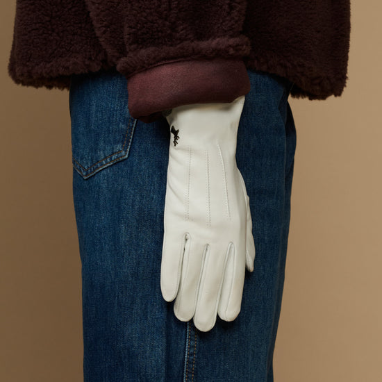 White sheepskin leather gloves with fleece lining, hanging straight wrist cuffs