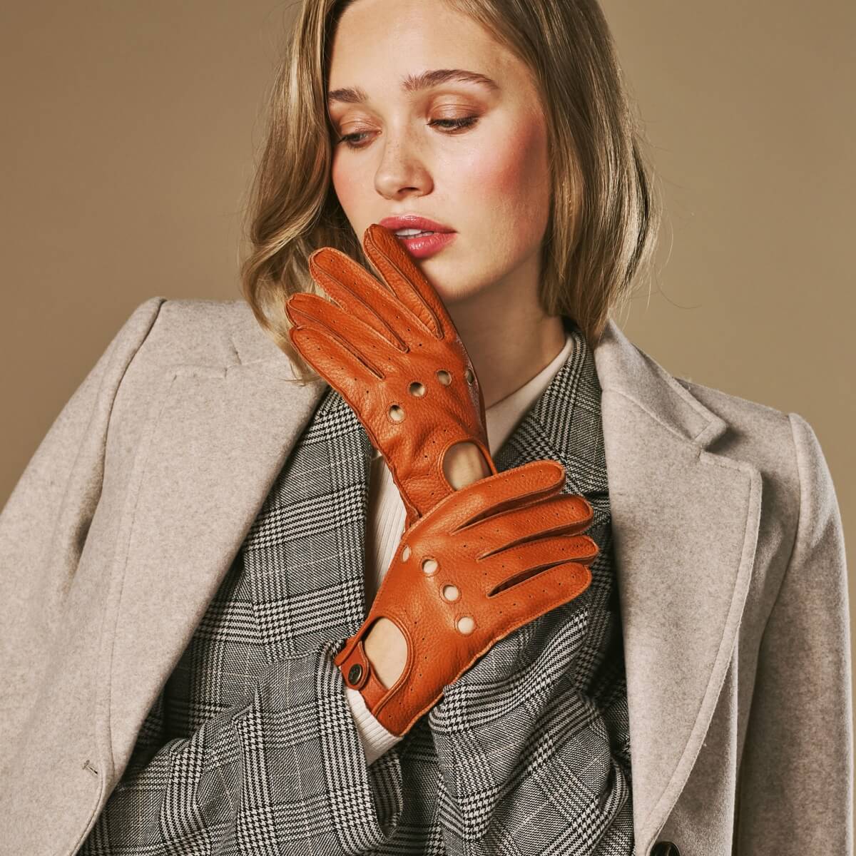 Cognac deerskin driving gloves with perforated detailing and snap wrist strap