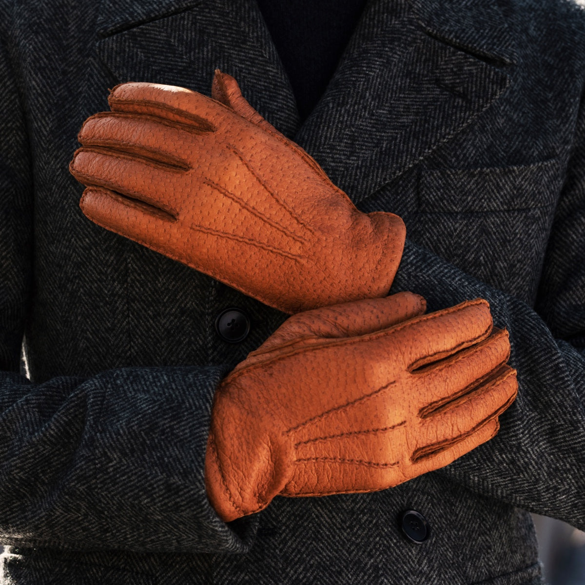 Cognac leather glove close-up with stitched fingers and cuff detail