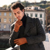 Man wearing cognac brown peccary leather gloves with cashmere-lined cuffs