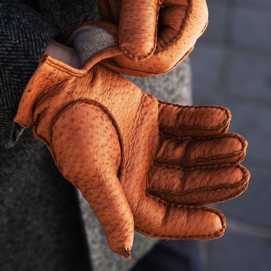 Close-up of cognac brown glove leather palms and finger stitching