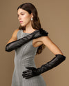 Women’s black leather elbow gloves, side view with arms posed, smooth finish