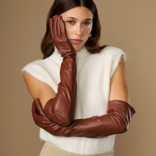 Chestnut brown lambskin opera gloves stacked at the wrist, sleek finish and seams