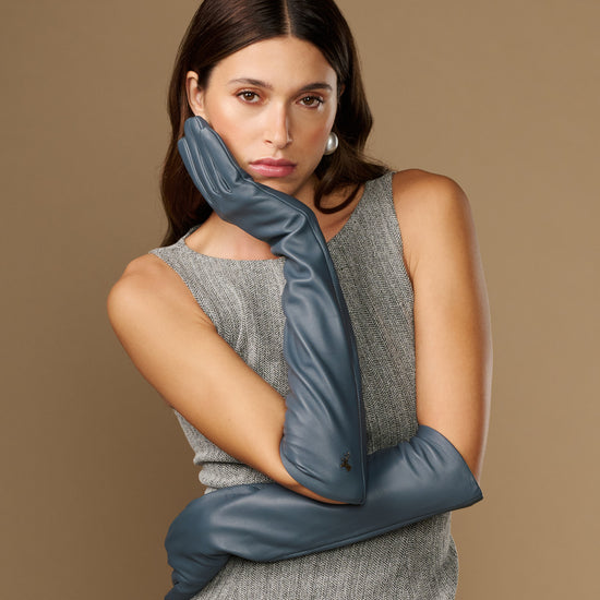 Dark blue leather glove with long cuff, close-up on model