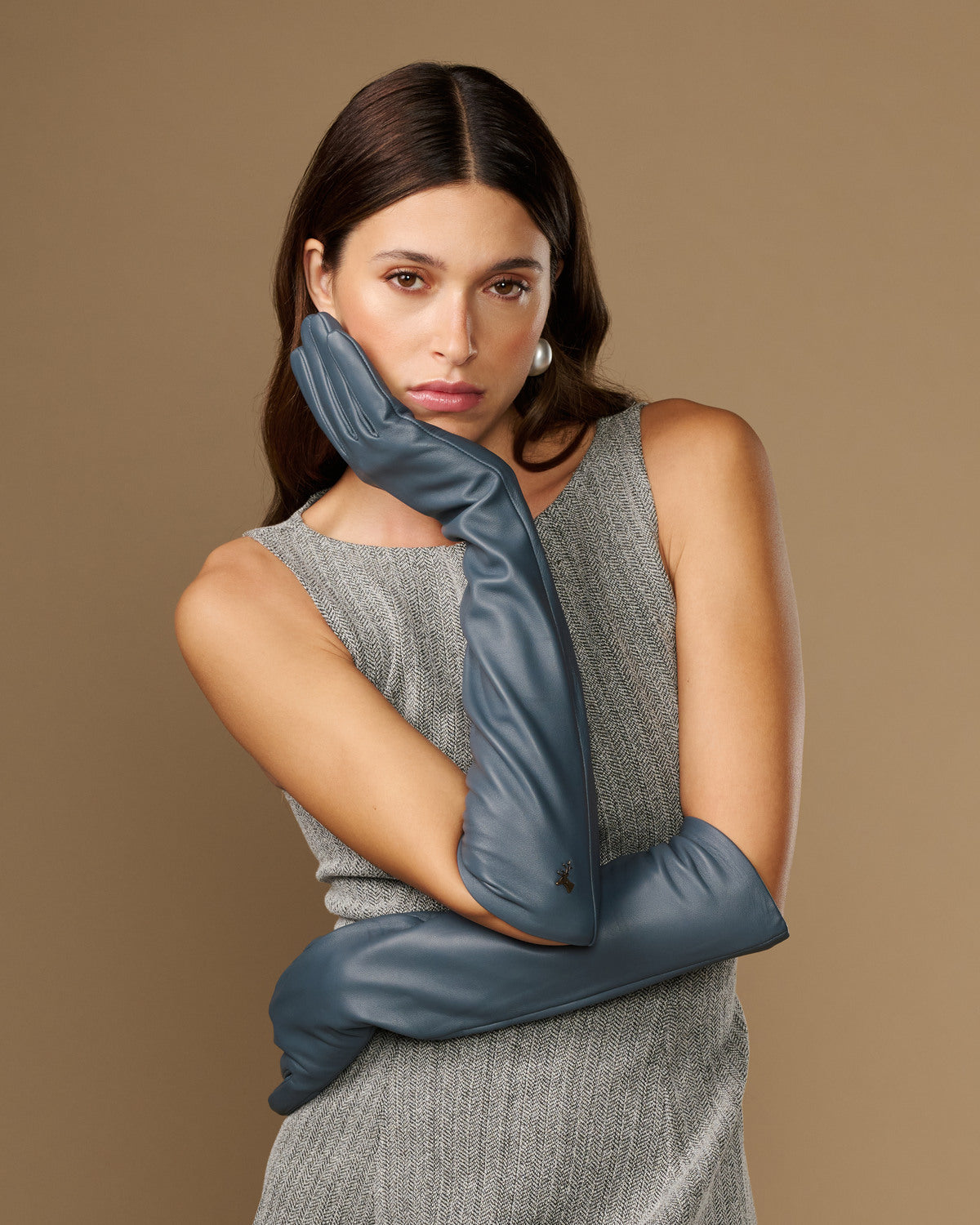 Dark blue leather glove with long cuff, close-up on model