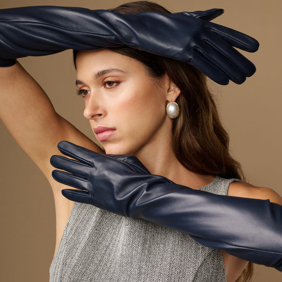 Women's blue leather elbow gloves with long arm coverage and seam details