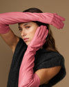 Women's pink leather gloves with extended wrist and fingers, side pose