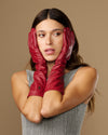 Women’s red below-elbow leather gloves with smooth finish and folded cuff detail