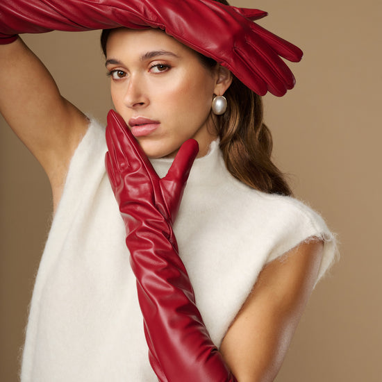 Red leather elbow gloves with long cuff and sleek stitched finger seams