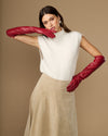 Red leather elbow gloves with padded-looking lining at wrist