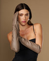 Taupe lambskin elbow-length leather glove close-up near face
