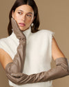 Close-up of taupe leather gloves showing long cuff and smooth knuckle area