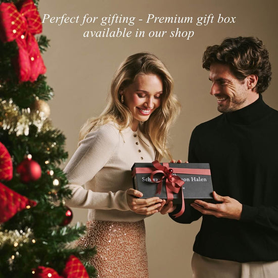 Holiday gift box with ribbon held by a smiling couple