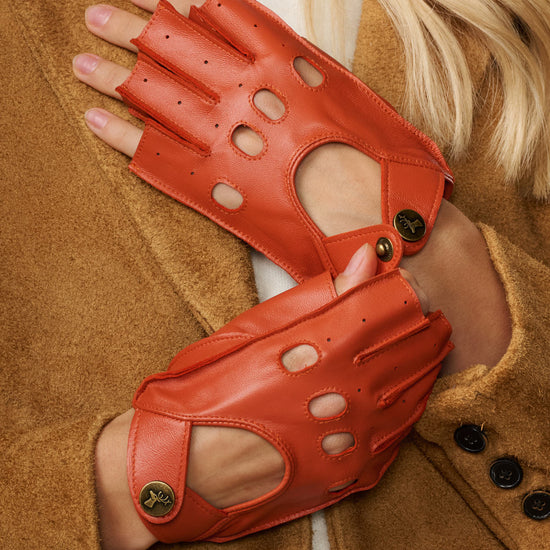 Orange fingerless leather driving gloves, oval cutouts and snap wrist strap