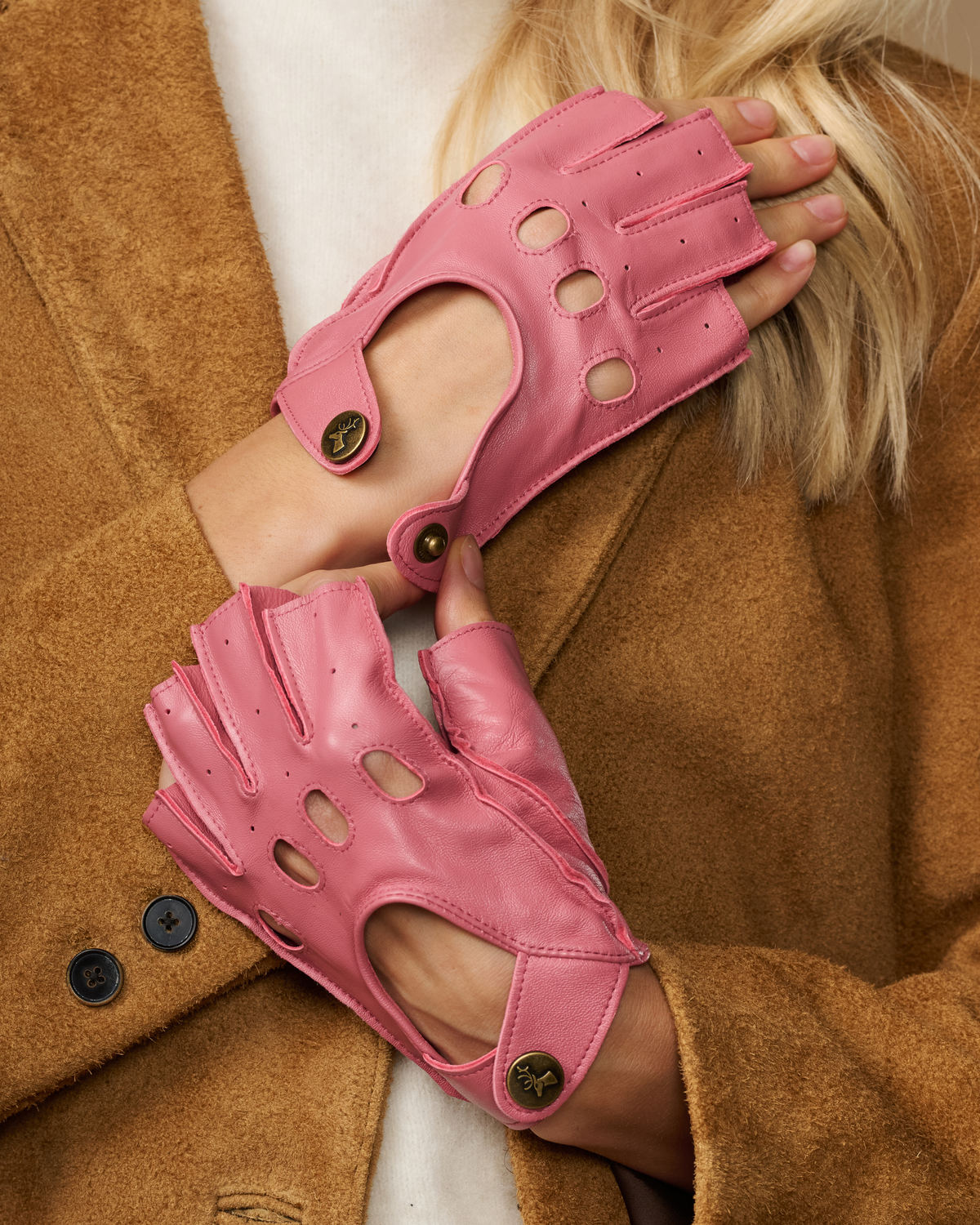 Pink fingerless driving gloves close-up with circular button details on back