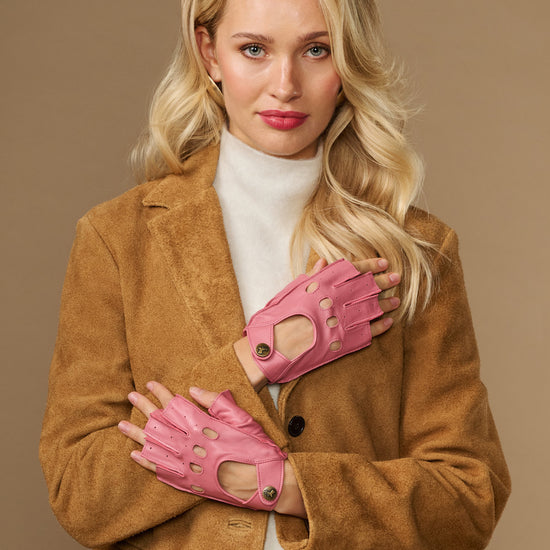 Pink fingerless lambskin driving gloves, worn with open finger tops and snaps