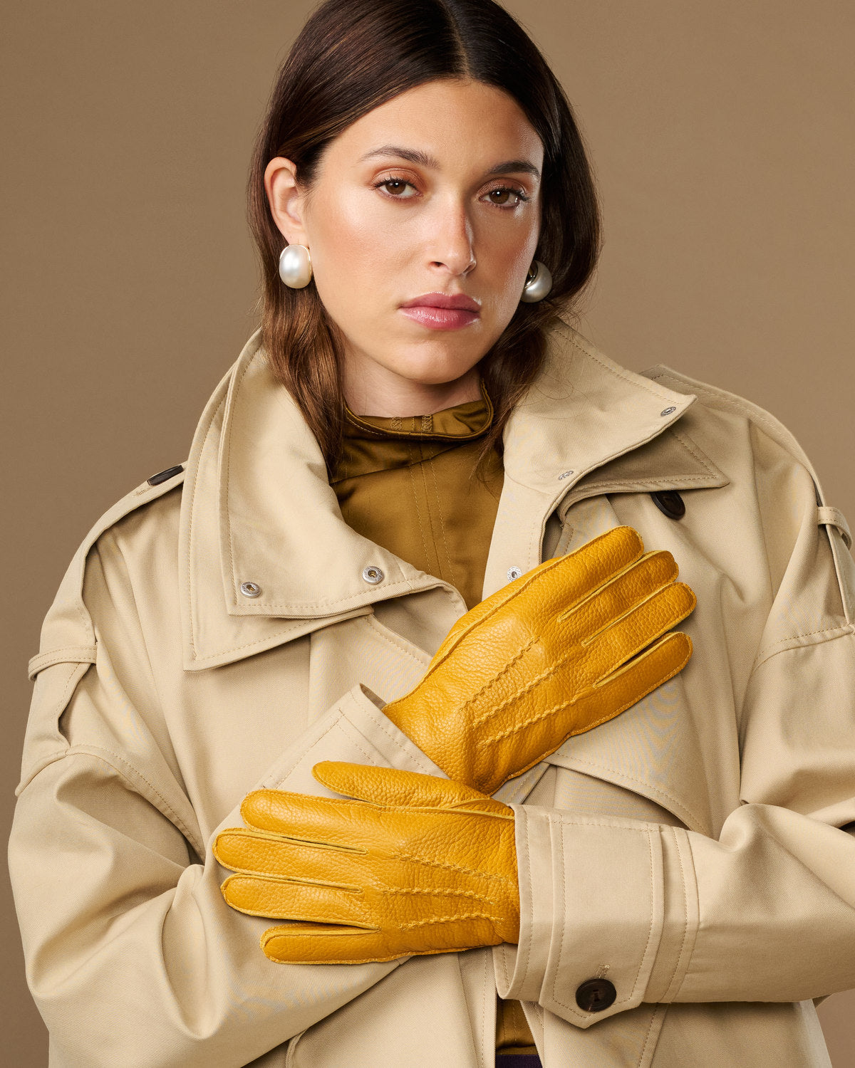 Yellow deerskin leather gloves with stitched fingers and snug wrist cuffs