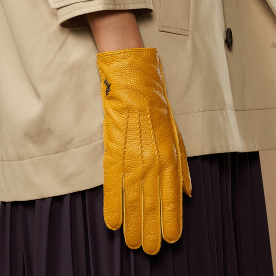 Yellow deerskin leather glove with vertical stitch detail and fitted wrist cuff