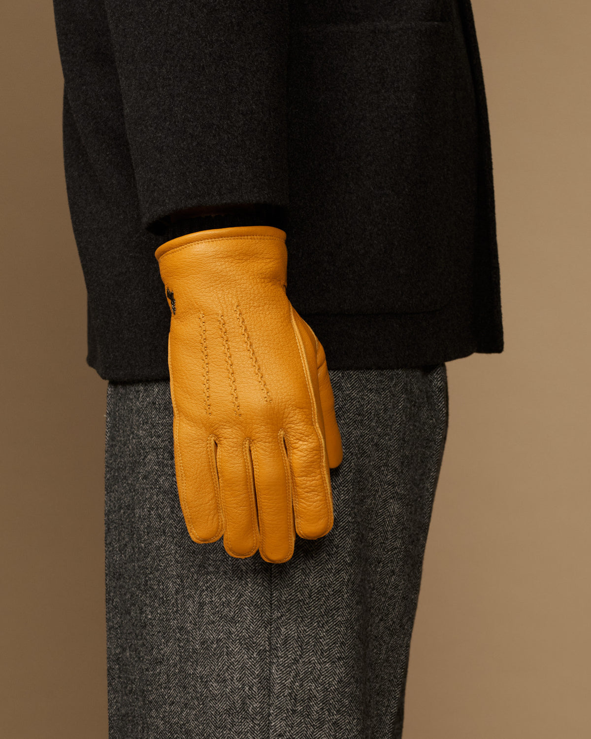 Yellow goatskin leather gloves, back view with stitched seams and gray cuff